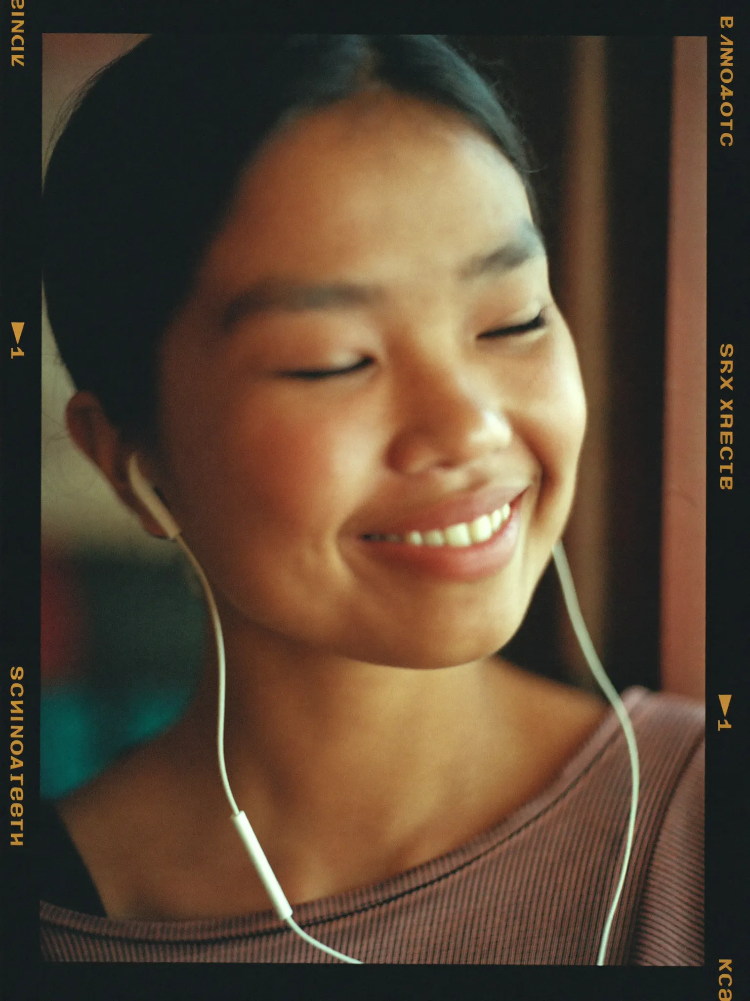 A young Nepali woman listening to a voice note